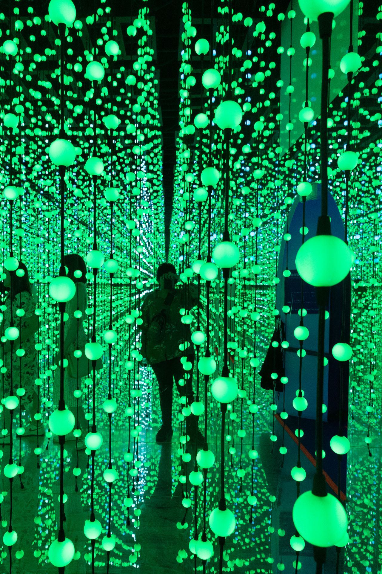 A photo of a woman standing amongst multiple lights taken on a Canon EOS R50 V mirrorless video camera