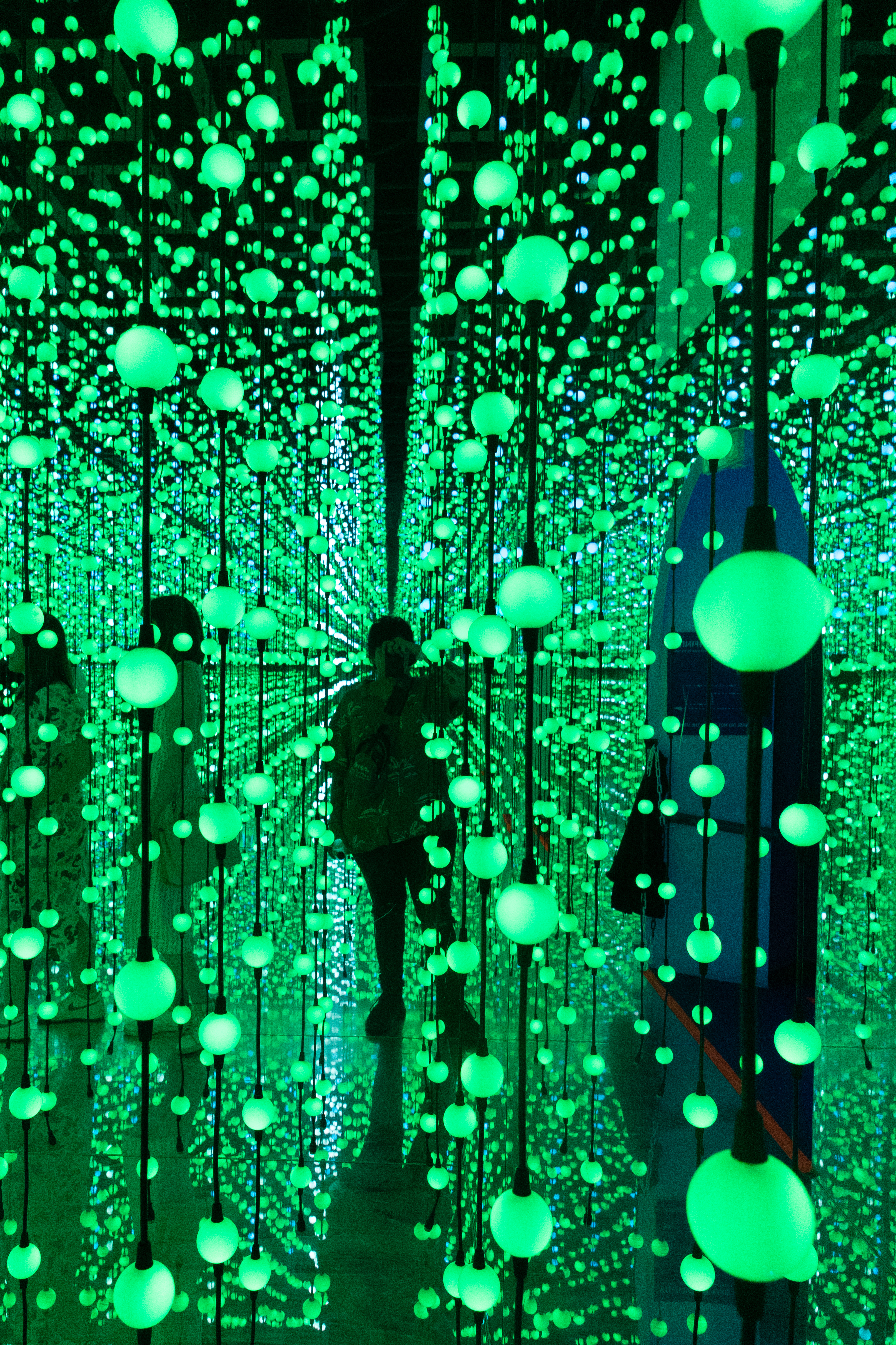 A photo of a woman standing amongst multiple lights taken on a Canon EOS R50 V mirrorless video camera