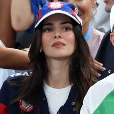 Kendall Jenner wears a ralph lauren hat ralph lauren jacket and a white tshirt