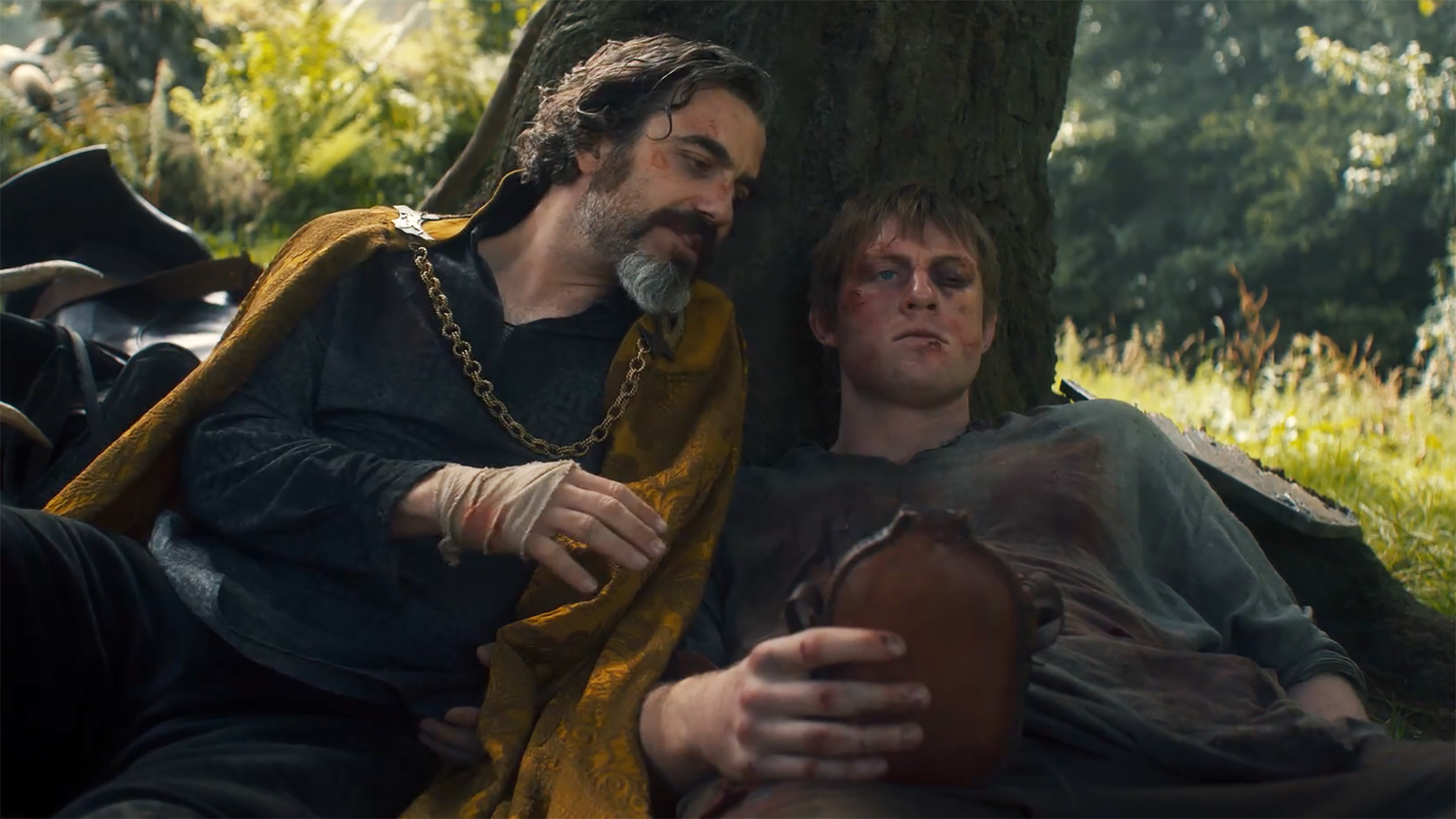 Lyonel lying next to a tree that's propping up Dunk in A Knight of the Seven Kingdoms episode 6