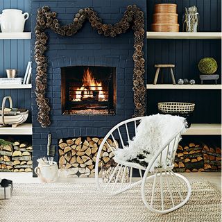 deep blue living room with fire place and white chair