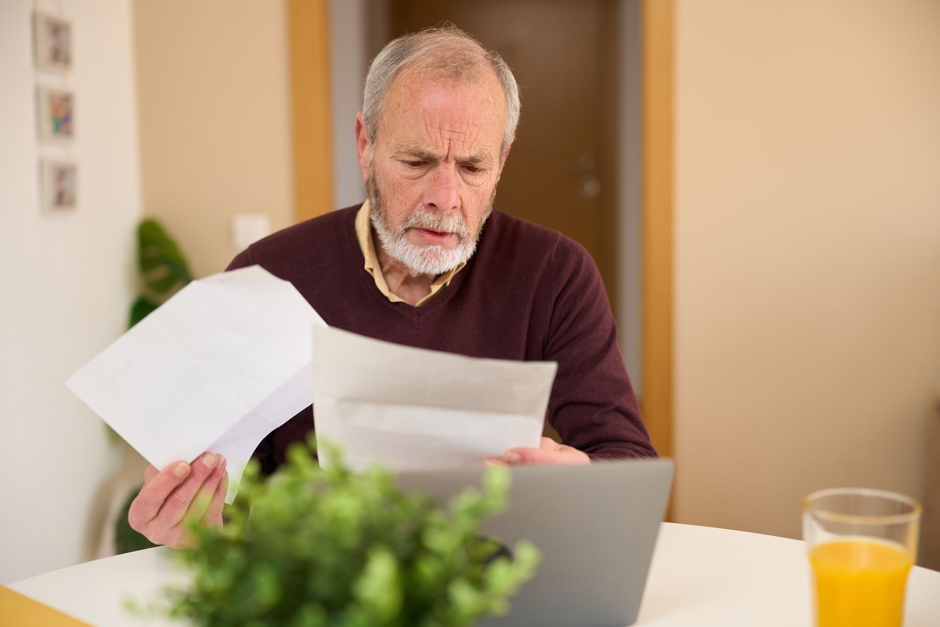 Man carefully reviewing documents at home