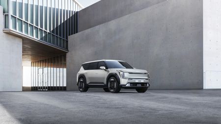 Kia EV9 SUV in front of brutalist building