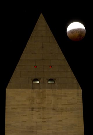 The Washington Monument is seen as the full moon is shadowed by the Earth during a total lunar eclipse on the arrival of the winter solstice, Tuesday, December 21, 2010 in Washington. From beginning to end, the eclipse lasted about three hours and twenty-