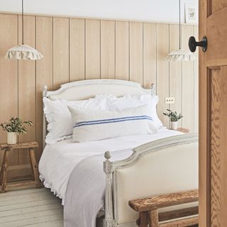 White bedspread in pannelled bedroom