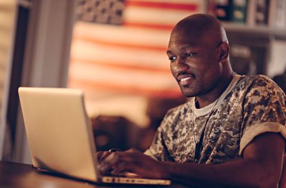 An American solider working at a computer