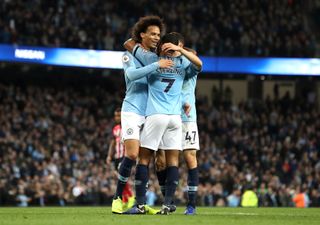 Manchester City's Leroy Sane (left) celebrates scoring his side's sixth goal of the game with Raheem Sterling (centre) and Phil Foden