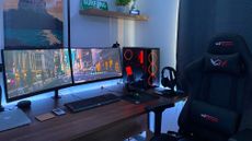 Best gaming monitors: Gaming monitor at desk with gaming chair and headphones 