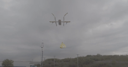 A drone carrying a package containing books.