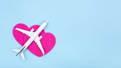 white plane on pink love heart