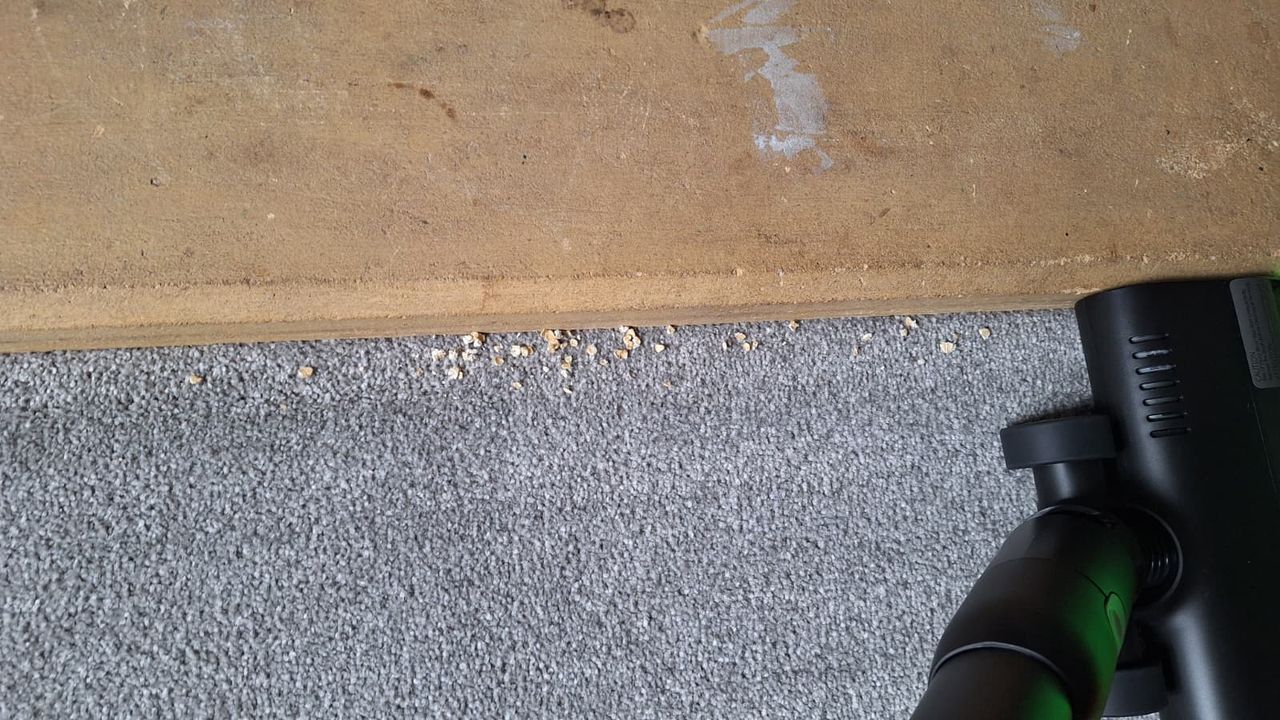 Oats being cleaned from along the side of a fireplace