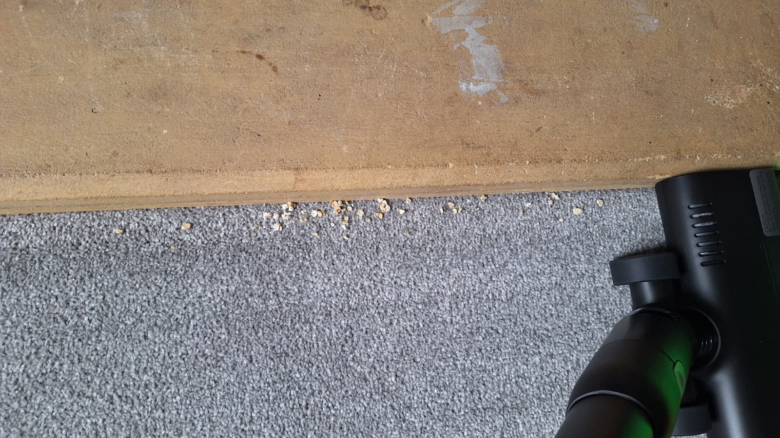 Oats being cleaned from along the side of a fireplace