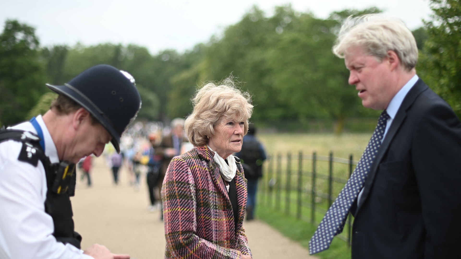 Earl Spencer and his sister Sarah outside Kensington Palace next to a police officer