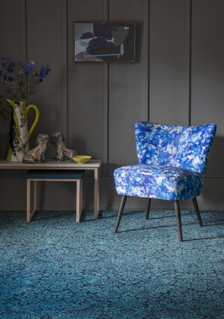 blue carpet in living room with vibrant chair