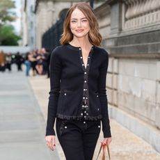 Emma stone wears a black jacket with black pants.