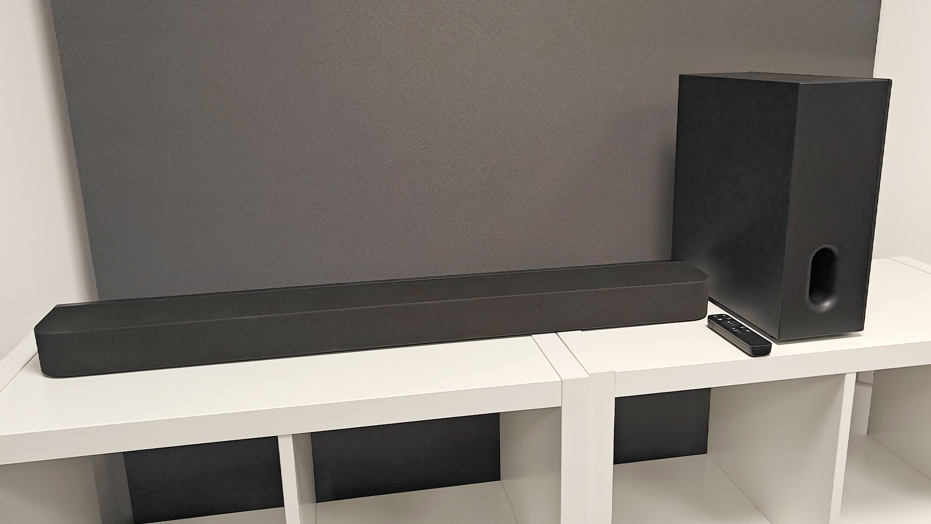 Sony Bravia Theatre Bar 7 + S soundbar package on white shelving unit with remote control