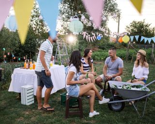 group of friends in garden with bunting and other party decorations