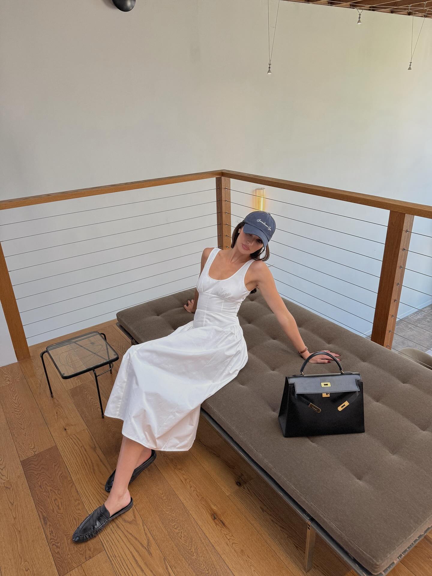 Pia Mance in a white Lioness dress and black loafers.