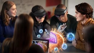 A group of standing around a holographic image in a classroom setting to depict what is seen in Microsoft HoloLens which is worn by two of the students