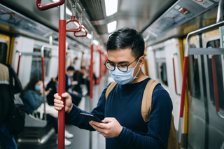 man wearing a face mask on a tube, something that we expect will still happen after Covid vaccinations
