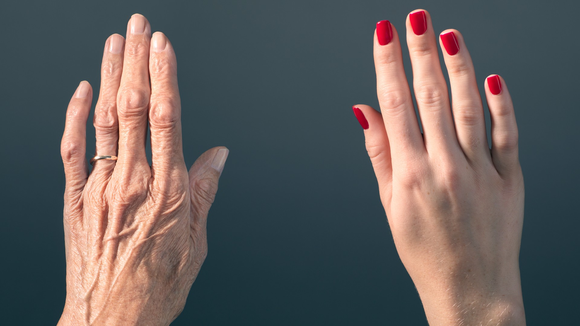 Picture of an elderly woman's hand beside a younger woman's hand.  Peter Finch via Getty Images