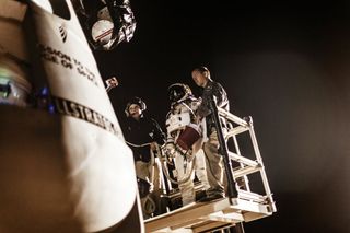 Baumgartner in Space Suit Stands on Forklift