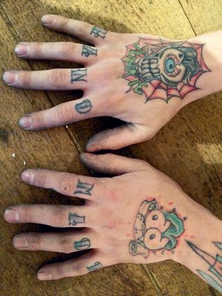 Fisher's 'handmade' knuckle tattoos