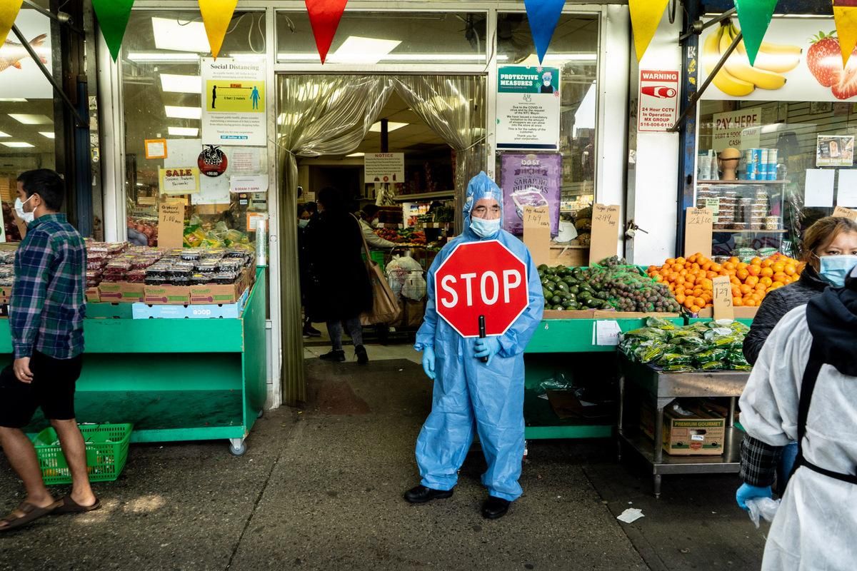 José, wearing protective gear and controlling entry to the H F Dollar &amp; Up Fruits &amp; Vegetables store, 61-27 Roosevelt Avenue, Queens, NY