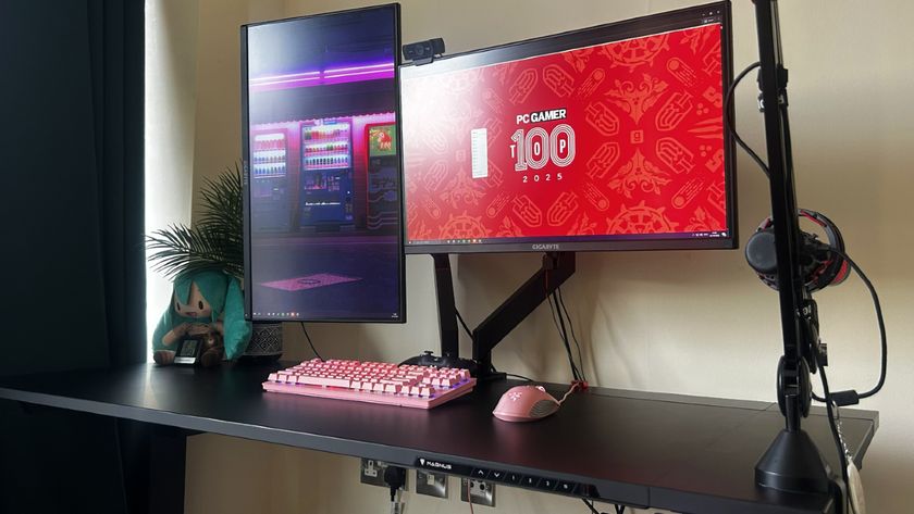 A Secretlab Magnus Evo desk complete with dual monitor arm displaying the PC Gamer Top 100.
