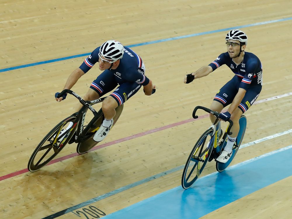 Morgan Kneisky(R) swing Benjamin Thomas of France forward in relay of the Men's Madison Final on Day 5 in 2017 UCI Track Cycling World Championships