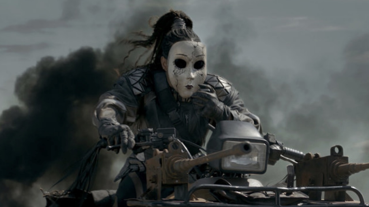 Masked Dollface driving surrounded by black smoke Twisted Metal Season 2