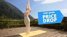 Woman practicing yoga outdoors on Liforme yoga mat with price drop deal badge top right corner