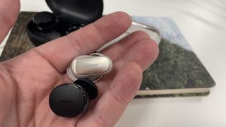 An earbud each of the Bose QuietComfort Earbuds Ultra and QuietComfort Earbuds (2024) in a hand.