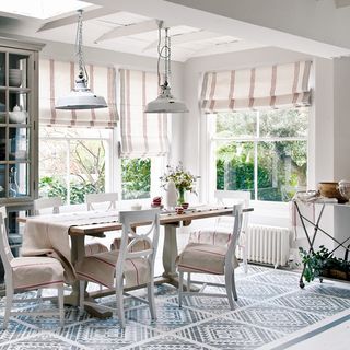 white dining room with table and lights