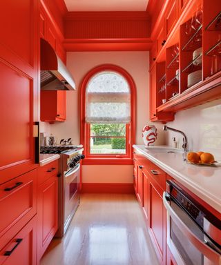 bright red modern kitchen with arched window