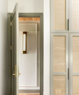 Narrow beige hallways with gold wall light fixtures