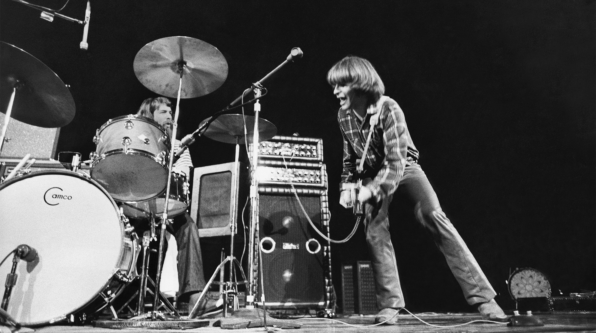 Rock and roll band Creedence Clearwater Revival performing with lead singer John Fogerty (to right) and drummer Doug Clifford (to the left).