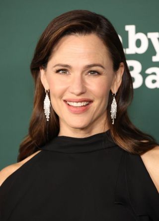 Actress Jennifer Garner wearing a chic black gown and striking silver earrings