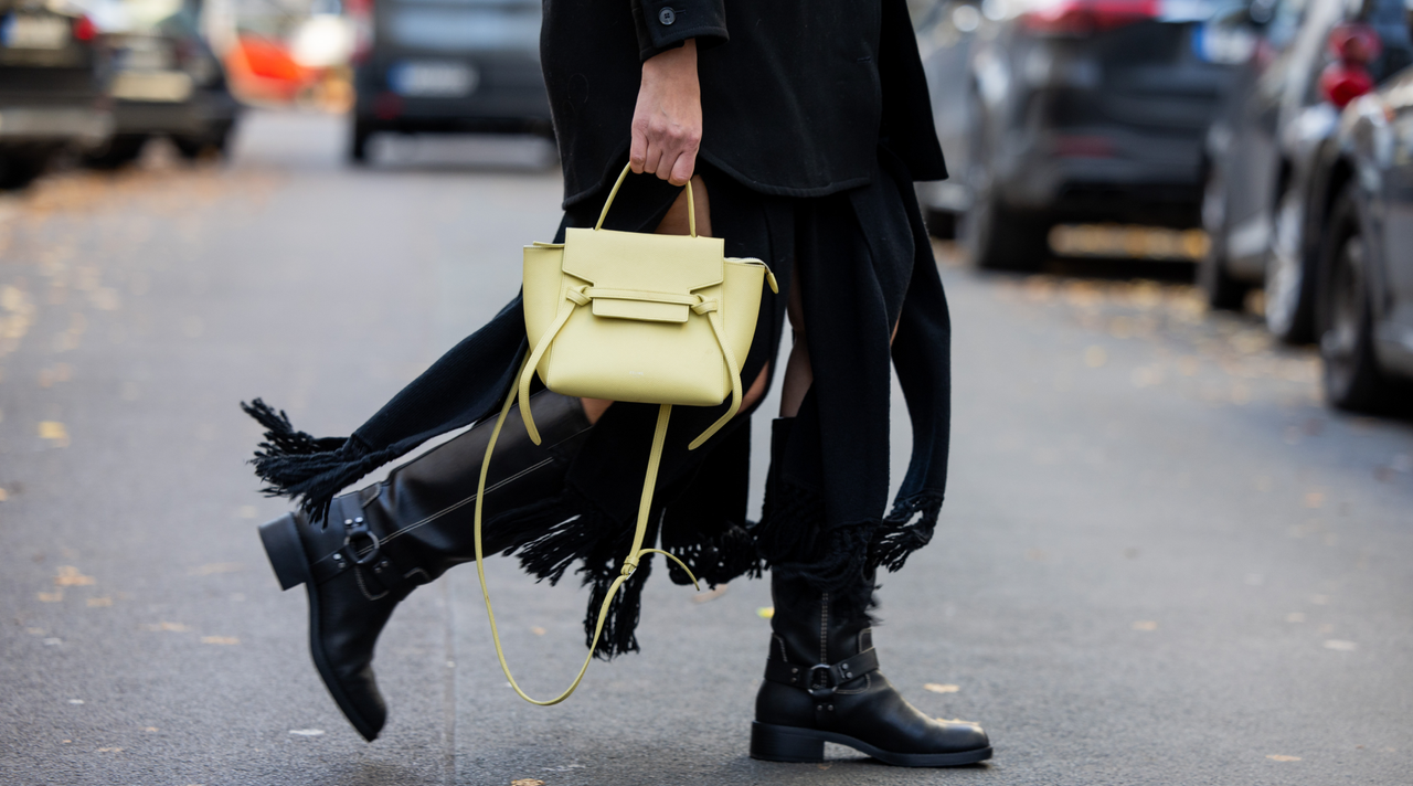  Victoria Scheu wears black fringe dress Cos, jacket &amp;other stories, sunnies off white, yellow Celine bag, white beanie, sweater, black boots, sunglasses on November 27, 2023 in Berlin, Germany