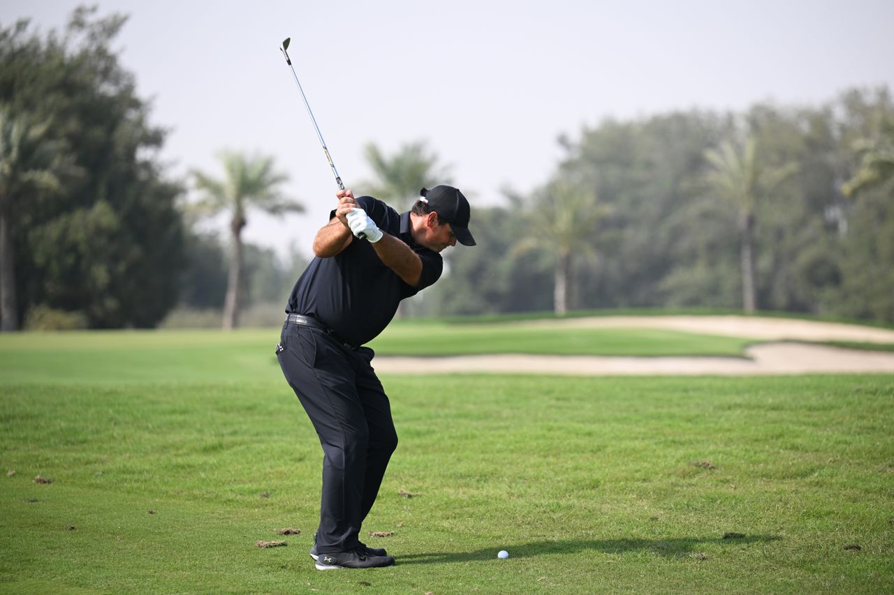 Patrick Reed hits a wedge from the rough