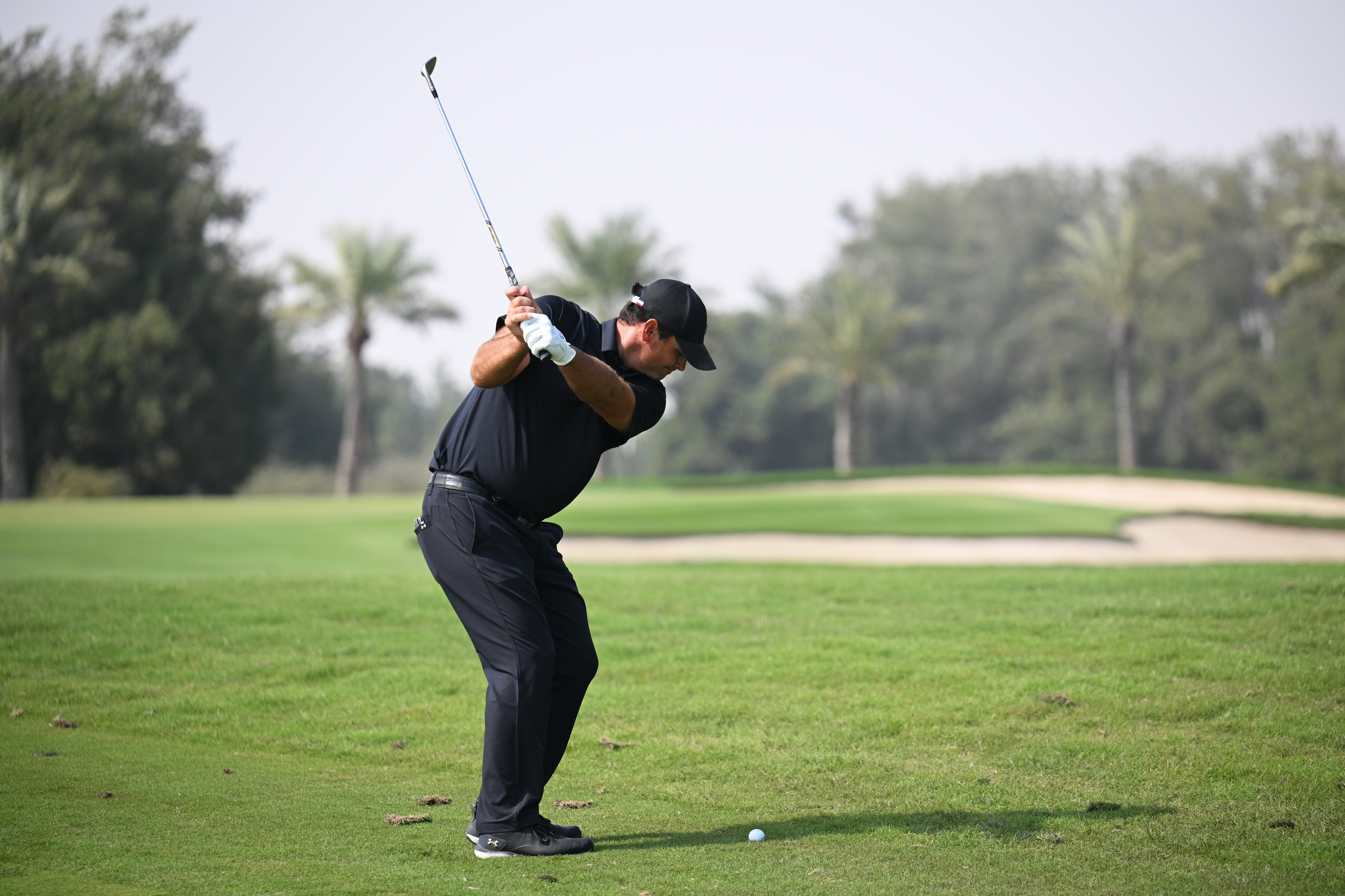 Patrick Reed hits a wedge from the rough