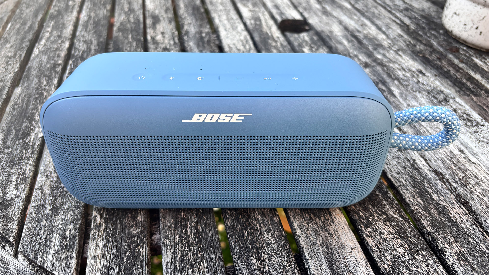 Bose SoundLink Plus wireless speaker on wooden garden table