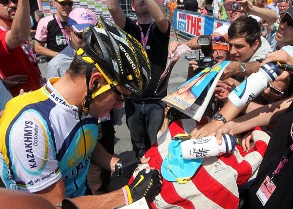 Lance Armstrong is kept busy prior to the start of stage two.