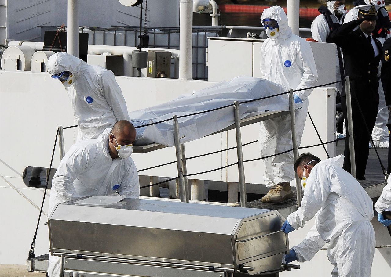 The Italian coast guard brings bodies to shore.