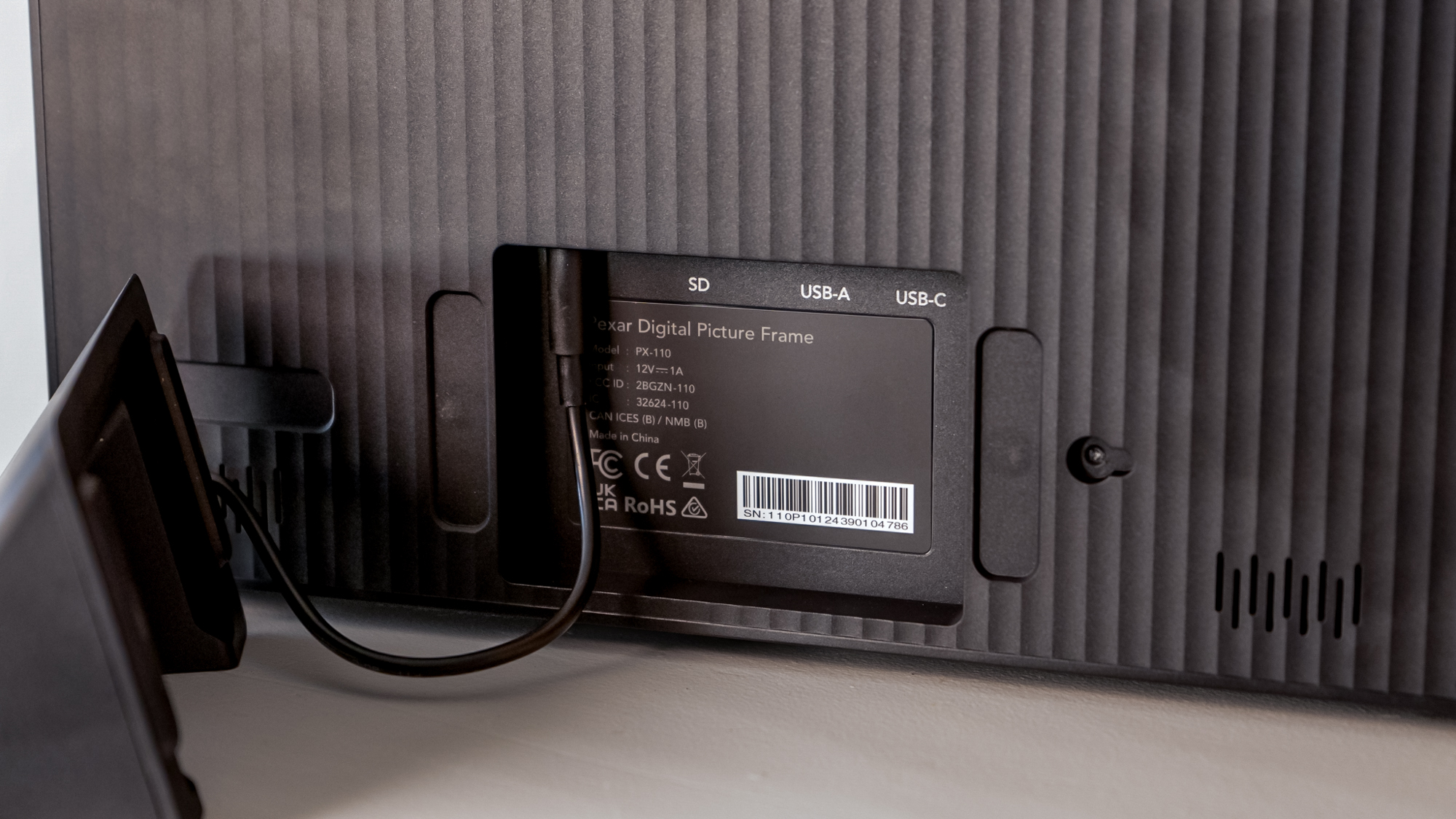 The power cable input on a Lexar Pexar 11-inch photo frame