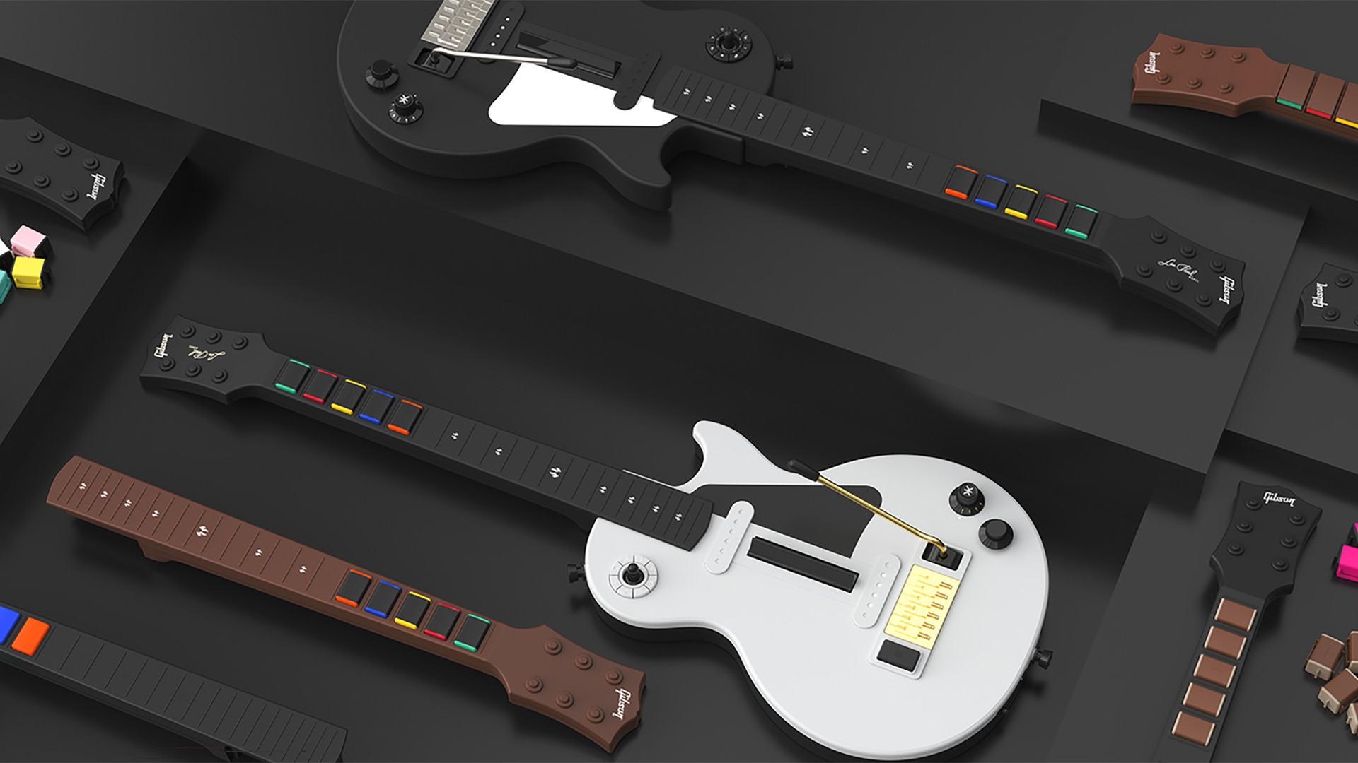 The two editions of the CRKD Les Paul Guitar Controller next to one another, with additional necks and fret buttons