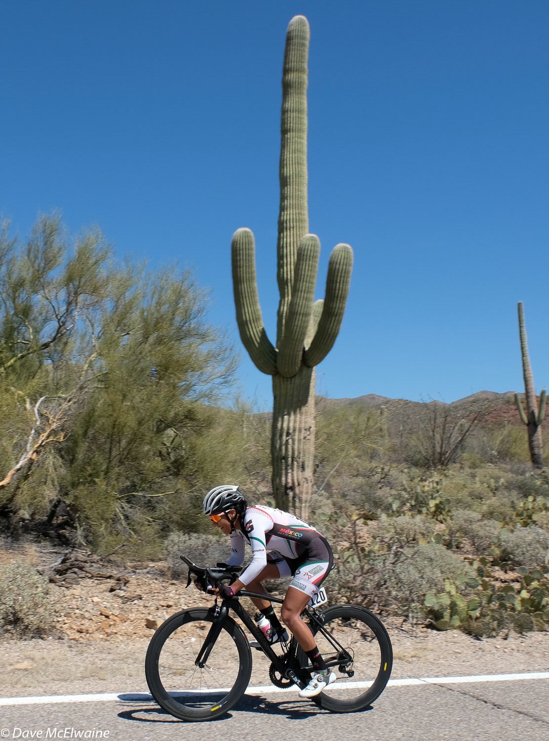 Anna Hernandez riding past a saguaro cactus during the time trial