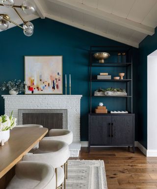 dining room with dark blue wall, white ceiling, wood flooring and wood dining table