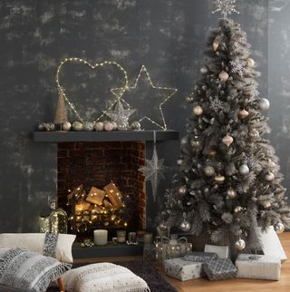 room with black textured wall and firplace area with chtristmas tree