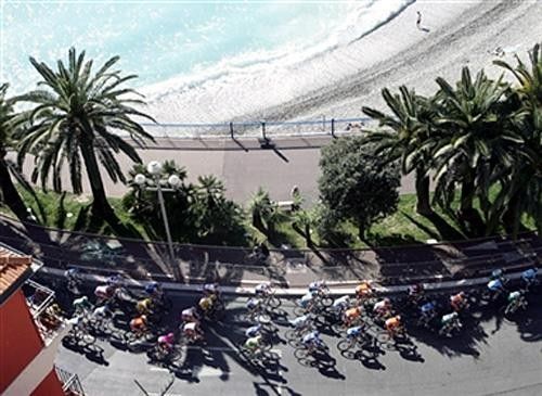 The peloton rides by the Promenade des Anglais in Nice